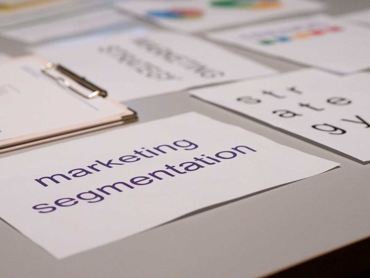about-img-01 Close-up of various marketing documents on a desk, perfect for business and strategy discussions.